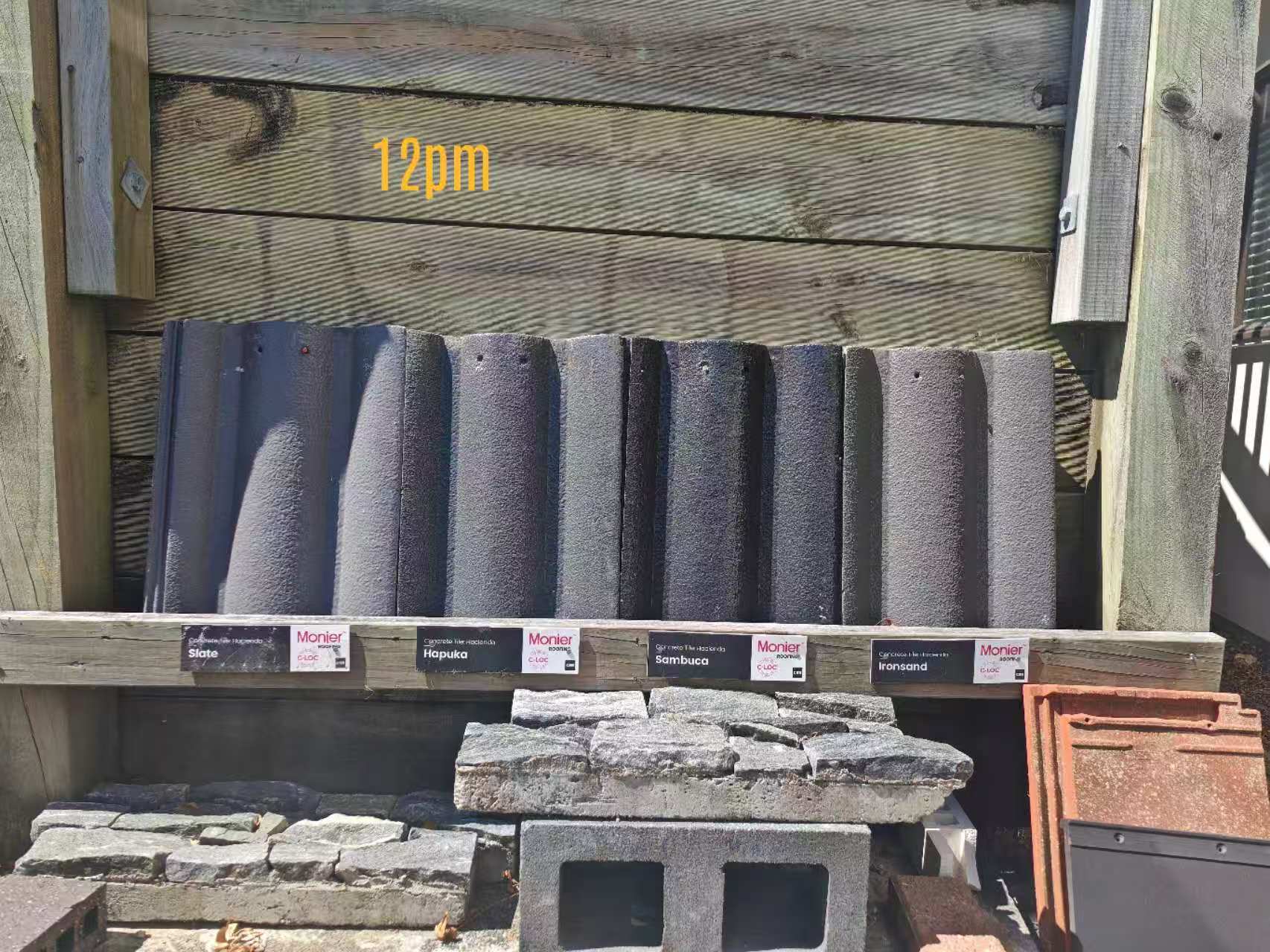 Hacienda profile concrete roof tiles in grey and black colours at 12pm